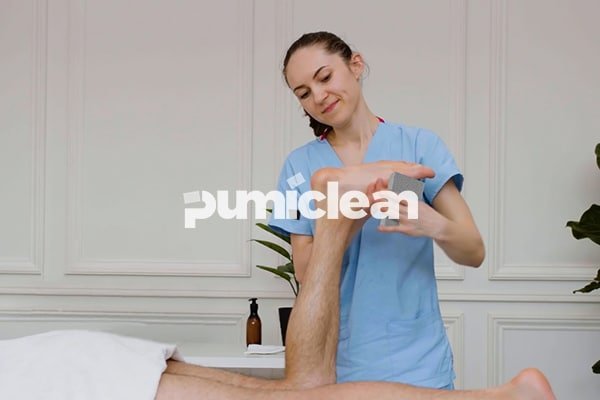 using pumice stone on wet feet in a spa setting